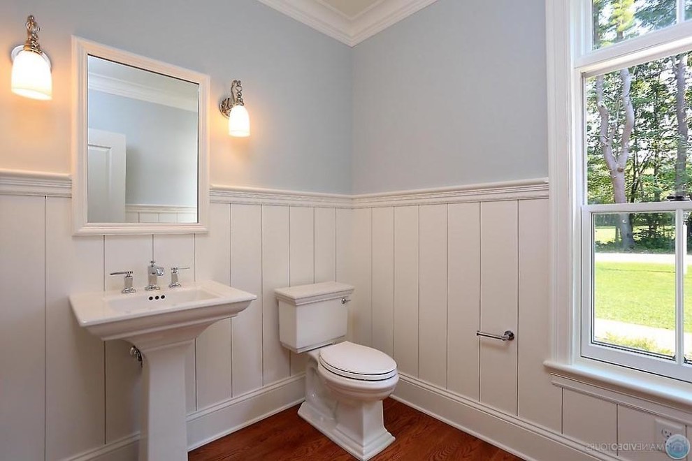 Example of a classic powder room design in Portland Maine with a pedestal sink and a two-piece toilet