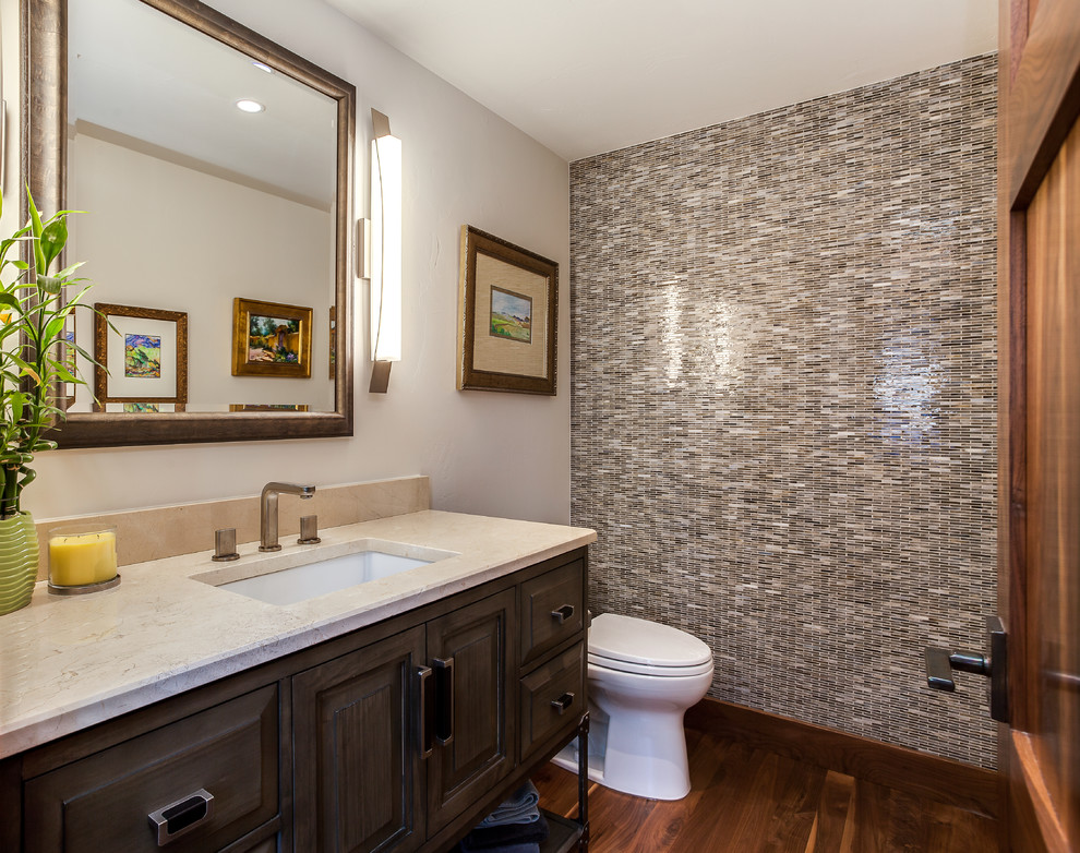 Mid-sized transitional beige tile, brown tile, gray tile, multicolored tile and matchstick tile dark wood floor powder room photo in Denver with furniture-like cabinets, dark wood cabinets, a two-piece toilet, beige walls, an undermount sink, limestone countertops and beige countertops