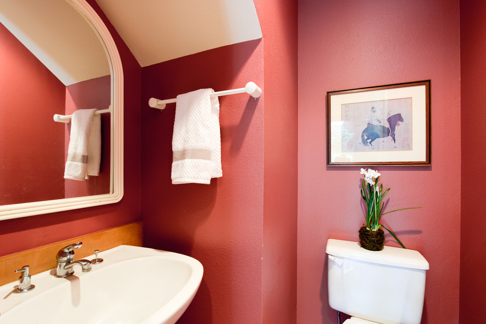 Photo of a small contemporary cloakroom in Seattle with a pedestal sink, a two-piece toilet and red walls.