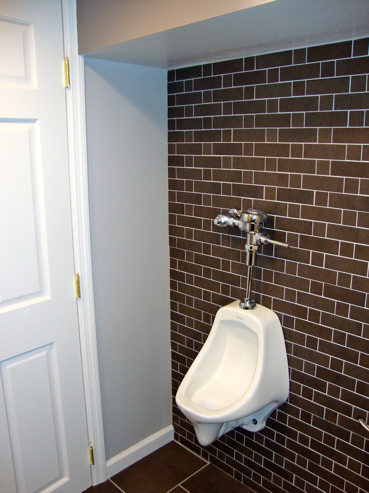 Medium sized industrial cloakroom in Other with recessed-panel cabinets, brown cabinets, grey walls, porcelain flooring, a submerged sink, granite worktops and brown floors.