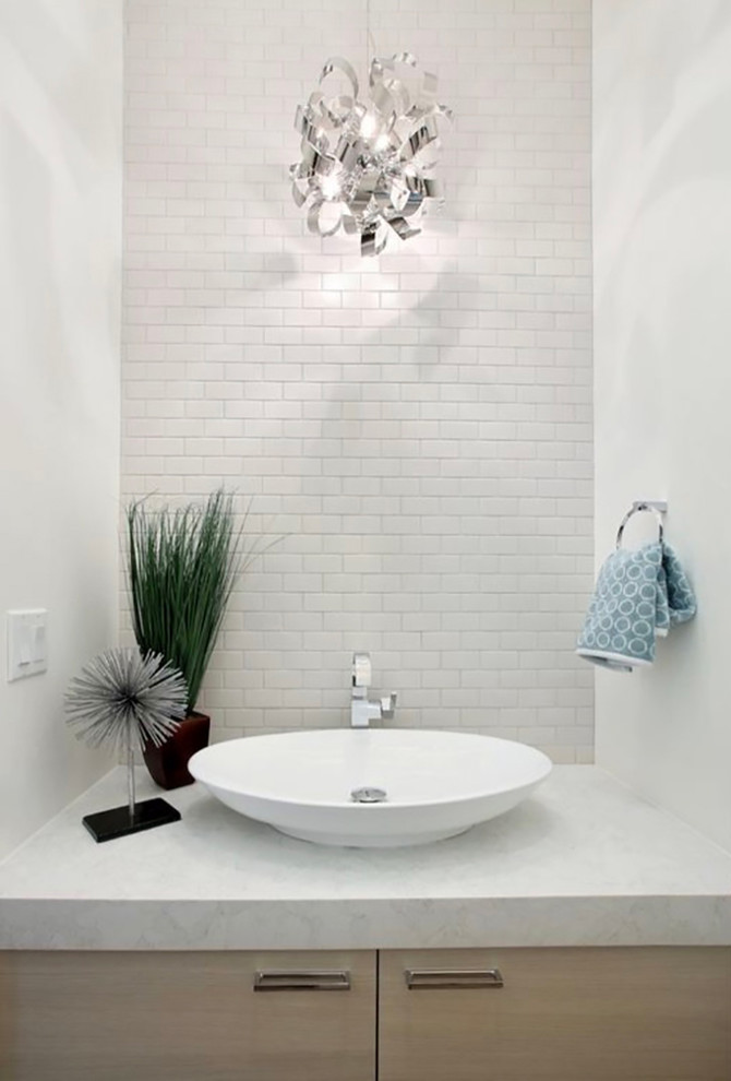 This is an example of a medium sized contemporary cloakroom in Denver with flat-panel cabinets, light wood cabinets, white tiles, cement tiles, white walls, a vessel sink, engineered stone worktops and white worktops.