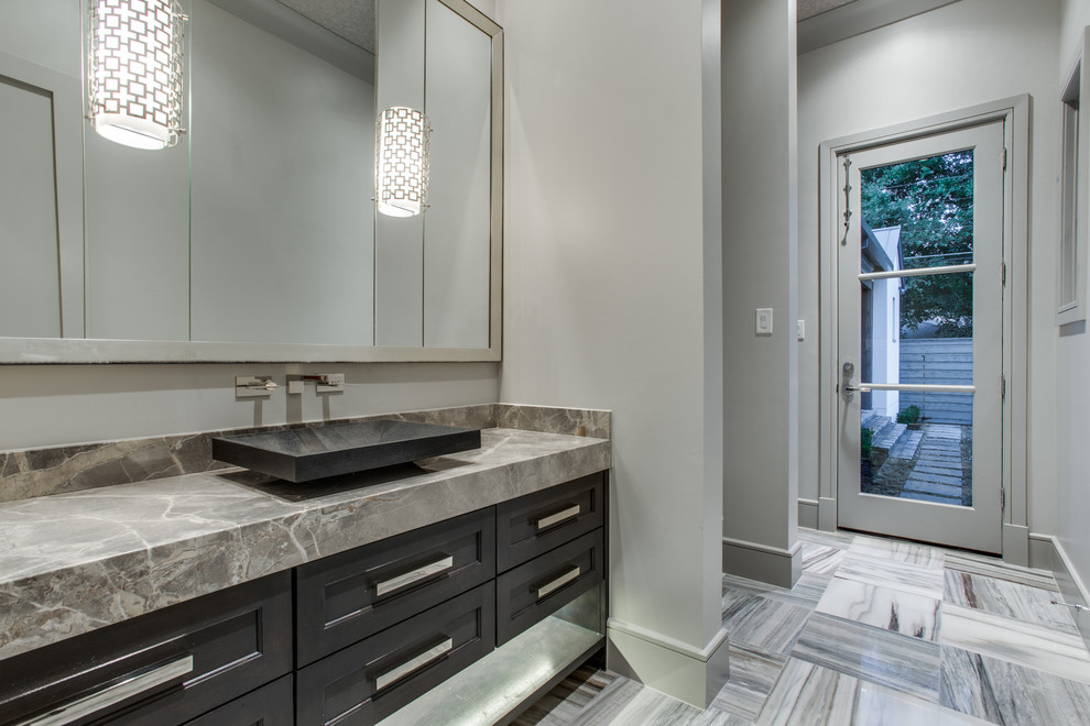 Inspiration for a large classic cloakroom in Dallas with a one-piece toilet, grey tiles, stone tiles, grey walls, marble flooring, a vessel sink, marble worktops, recessed-panel cabinets and grey cabinets.