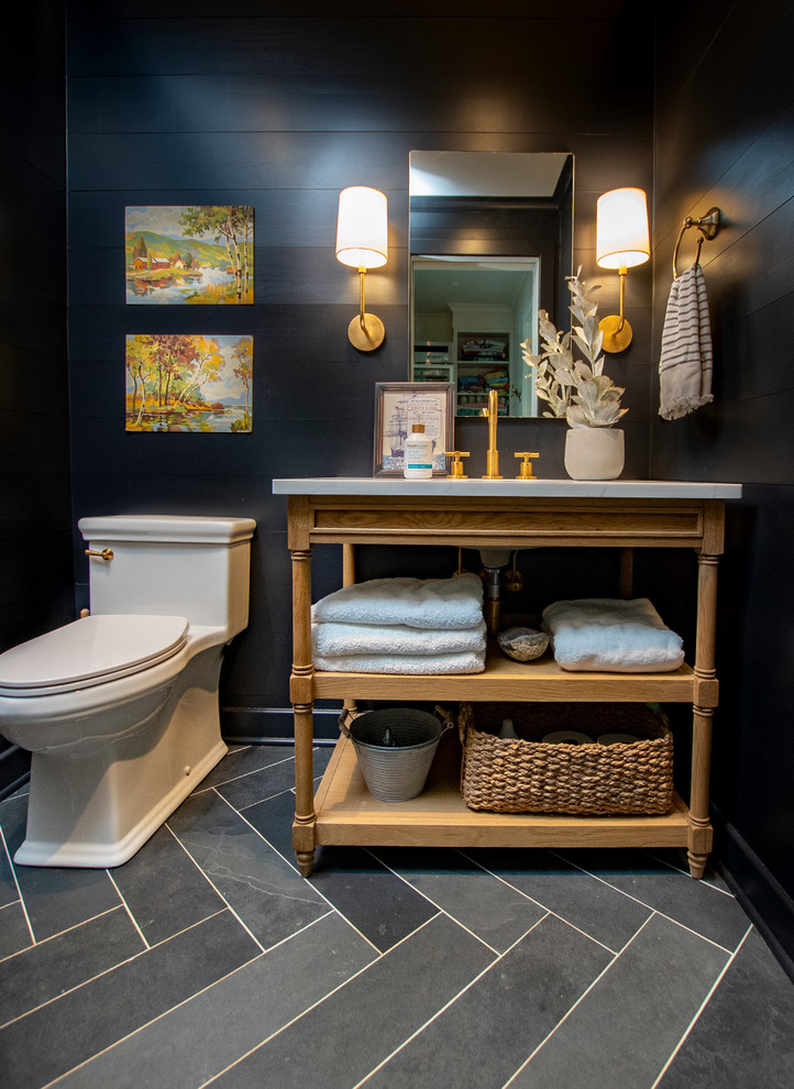 This is an example of a small country cloakroom in Other with open cabinets, light wood cabinets, a one-piece toilet, black walls, slate flooring, a submerged sink, engineered stone worktops, black floors and white worktops.