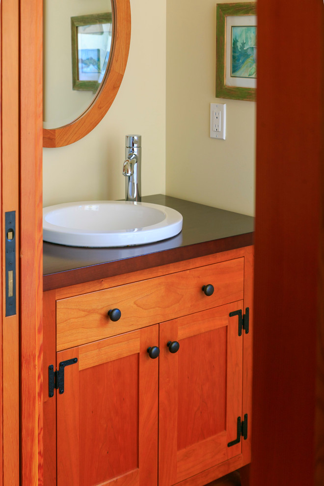 Small classic cloakroom in Vancouver with shaker cabinets, medium wood cabinets and a built-in sink.