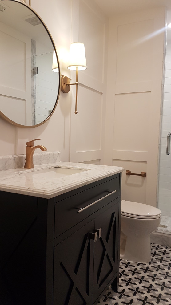 Photo of a small traditional cloakroom in Houston with freestanding cabinets, black cabinets, a one-piece toilet, white tiles, metro tiles, white walls, marble flooring, a built-in sink, marble worktops, multi-coloured floors, grey worktops, a freestanding vanity unit and panelled walls.
