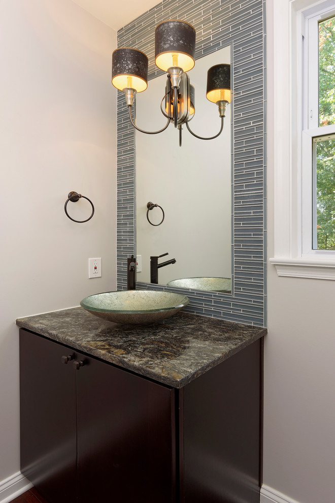 Example of a mid-sized eclectic matchstick tile and blue tile powder room design in DC Metro with a vessel sink, flat-panel cabinets, dark wood cabinets, granite countertops, a two-piece toilet and gray walls