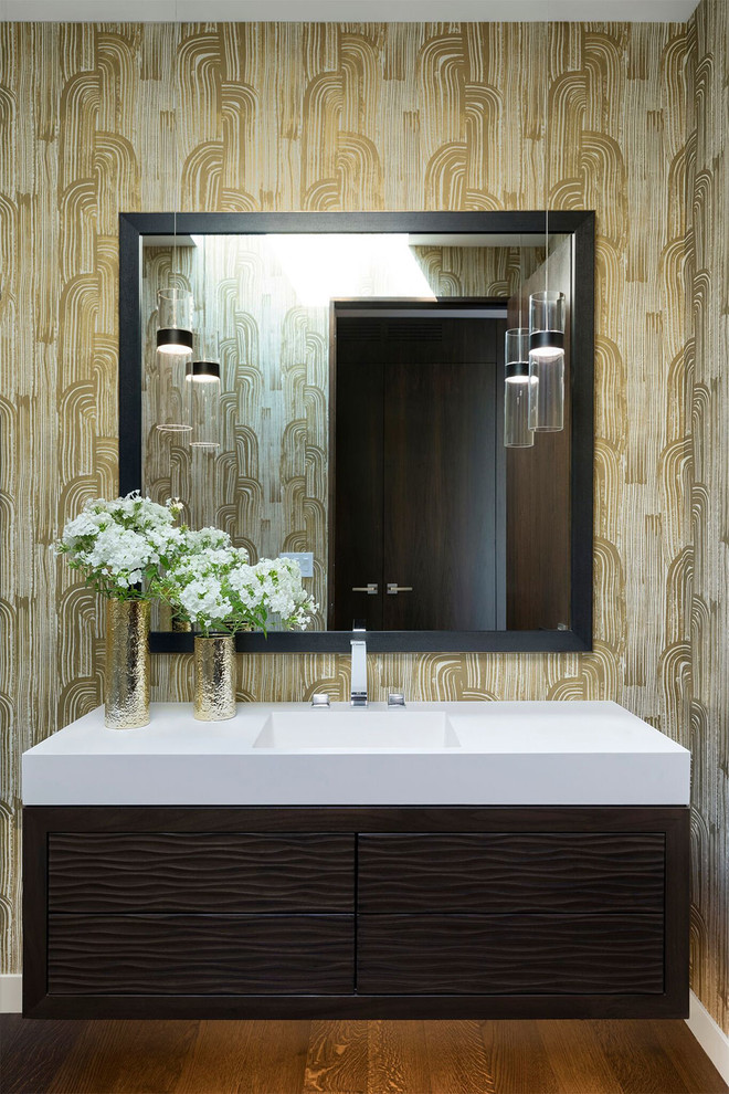 This is an example of a contemporary cloakroom in Minneapolis with flat-panel cabinets, dark wood cabinets, beige walls, medium hardwood flooring, an integrated sink, brown floors and white worktops.