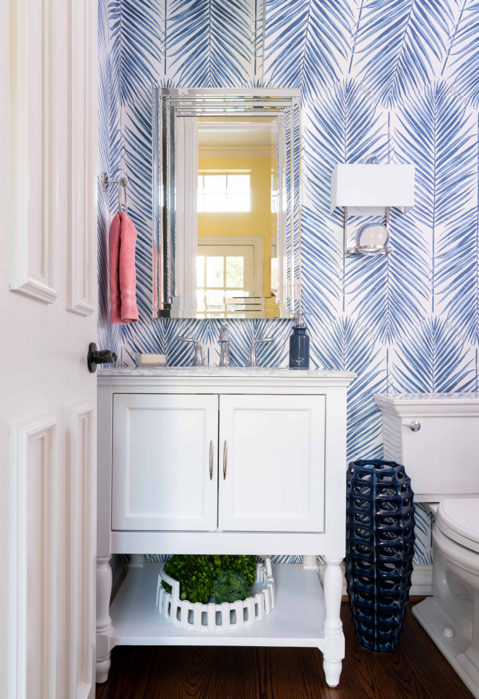 ダラスにある高級な小さなトランジショナルスタイルのおしゃれなトイレ・洗面所 (家具調キャビネット、白いキャビネット、青い壁、濃色無垢フローリング、茶色い床、白い洗面カウンター、大理石の洗面台) の写真