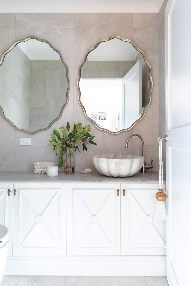 Medium sized world-inspired cloakroom in Sunshine Coast with shaker cabinets, white cabinets, a wall mounted toilet, beige tiles, ceramic tiles, ceramic flooring, a vessel sink, granite worktops, beige floors and multi-coloured worktops.