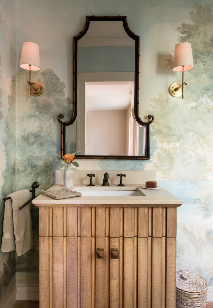 Cette image montre un WC et toilettes traditionnel en bois brun avec un placard en trompe-l'oeil, un mur multicolore, un sol en bois brun, un lavabo encastré, un sol marron et un plan de toilette beige.