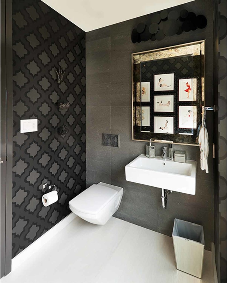 Ispirazione per un bagno di servizio minimalista di medie dimensioni con WC sospeso, piastrelle grigie, pareti grigie, pavimento in gres porcellanato e lavabo sospeso