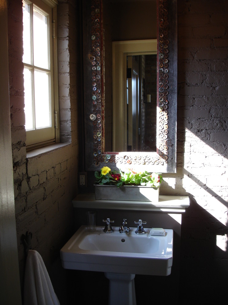 Small powder room photo in Grand Rapids with a pedestal sink and gray walls