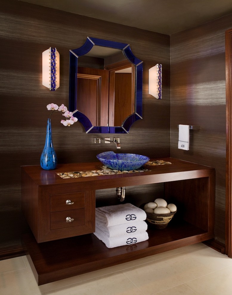 Example of a mid-sized mountain style powder room design in San Francisco with a vessel sink, flat-panel cabinets, dark wood cabinets, wood countertops and brown countertops