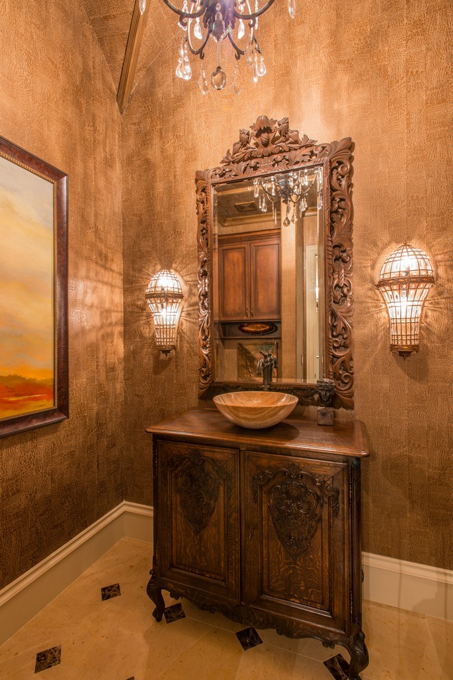 Powder room - mid-sized mediterranean marble floor powder room idea in Dallas with furniture-like cabinets, dark wood cabinets, brown walls, a vessel sink and wood countertops