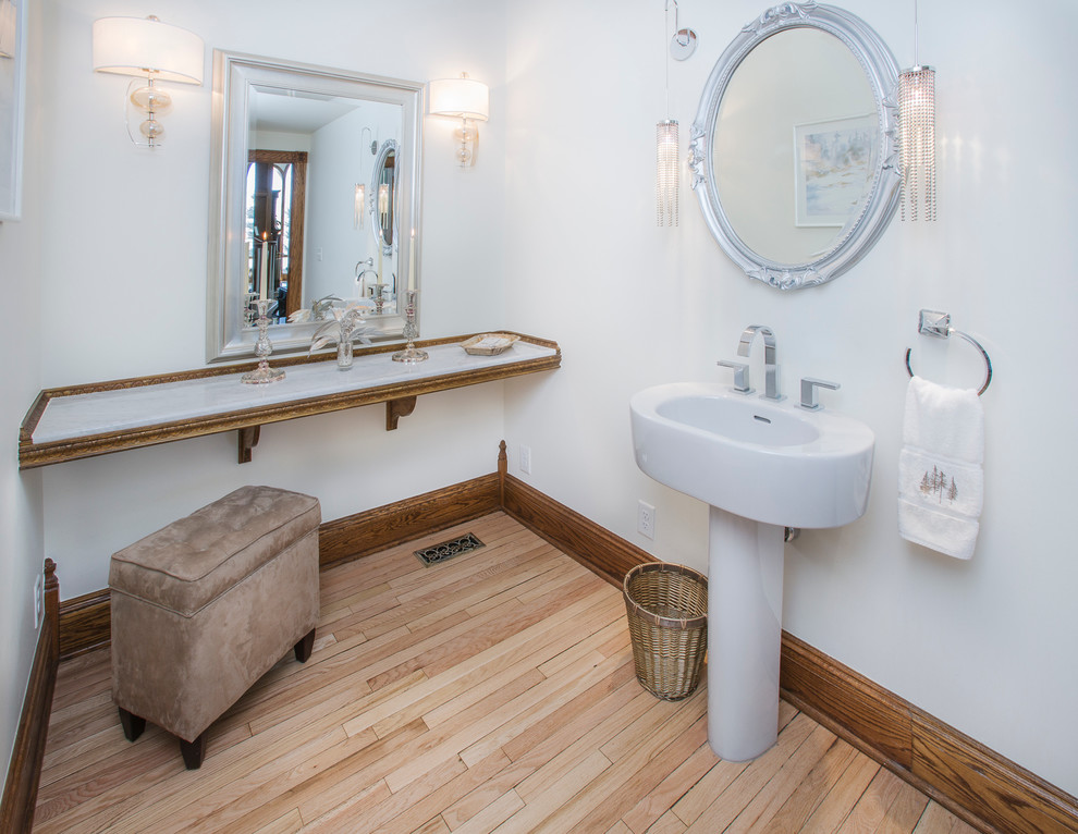 Design ideas for a medium sized contemporary cloakroom in Denver with marble worktops, white walls, light hardwood flooring and a pedestal sink.