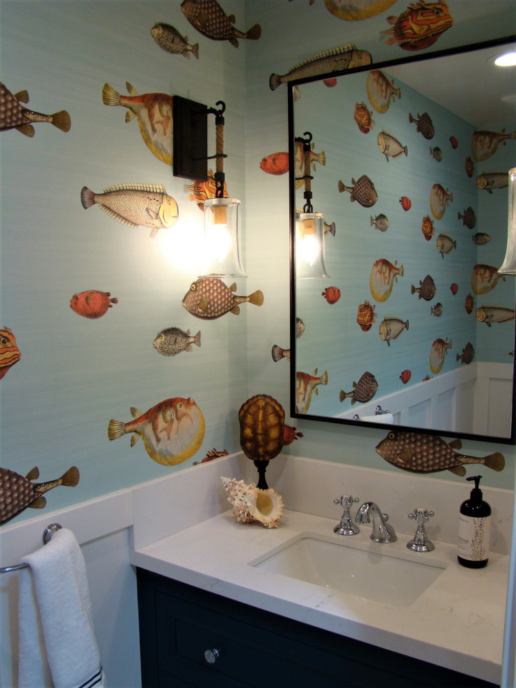 Inspiration for a small coastal porcelain tile, beige floor and wallpaper powder room remodel in San Francisco with shaker cabinets, blue cabinets, white walls, an undermount sink, quartz countertops, white countertops and a built-in vanity