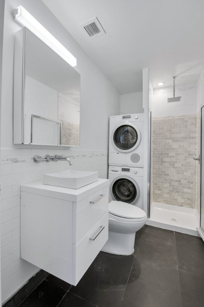 Mid-sized minimalist white tile and porcelain tile porcelain tile and black floor powder room photo in New York with flat-panel cabinets, white cabinets, a one-piece toilet, white walls, a vessel sink, quartzite countertops, white countertops and a floating vanity