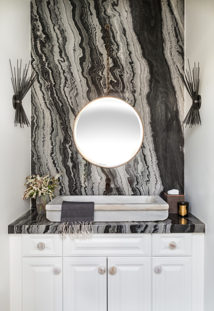 Design ideas for a classic cloakroom in Los Angeles with raised-panel cabinets, white cabinets, white walls, a vessel sink, black worktops and a feature wall.