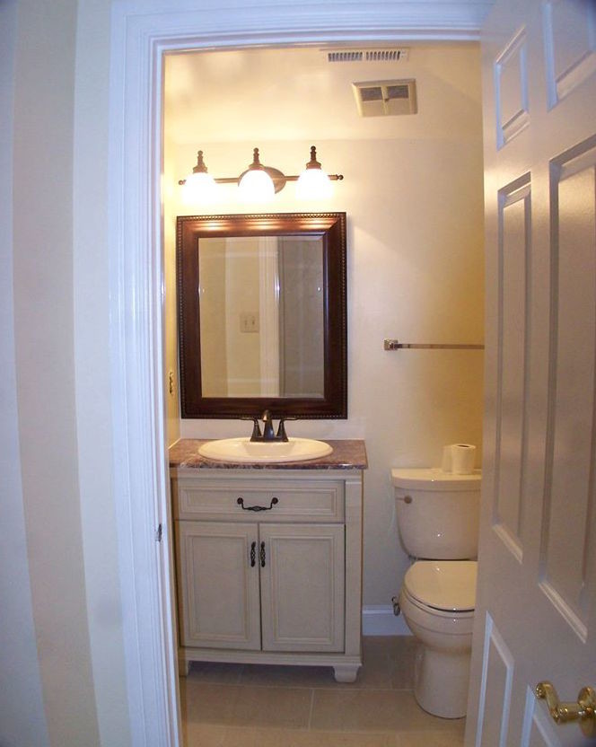 Inspiration pour un WC et toilettes traditionnel de taille moyenne avec des portes de placard beiges, un mur beige, un sol en carrelage de céramique, un plan de toilette en granite, un placard avec porte à panneau encastré, WC séparés, un lavabo posé et un sol beige.