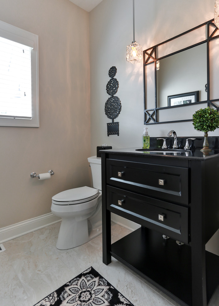 Powder room - small transitional beige tile and porcelain tile porcelain tile powder room idea in Milwaukee with recessed-panel cabinets, a two-piece toilet, beige walls, an undermount sink, solid surface countertops and black cabinets