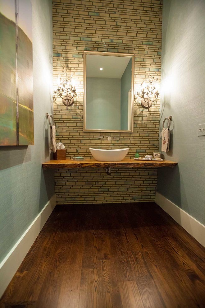 Mid-sized trendy beige tile and ceramic tile dark wood floor and brown floor powder room photo in Charlotte with wood countertops, open cabinets, medium tone wood cabinets, blue walls and a vessel sink