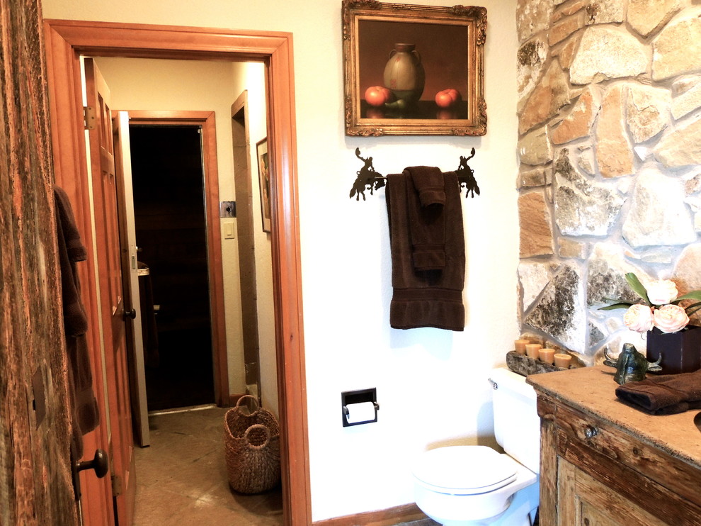 Inspiration for a rustic powder room remodel in Austin