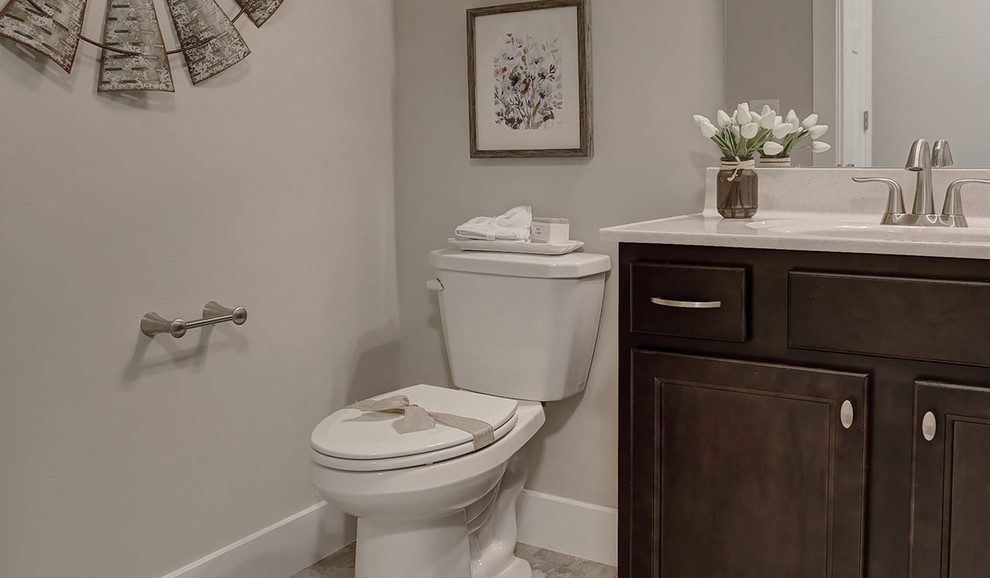 This is an example of a medium sized country cloakroom in Other with dark wood cabinets, a two-piece toilet, grey walls, ceramic flooring, an integrated sink and marble worktops.