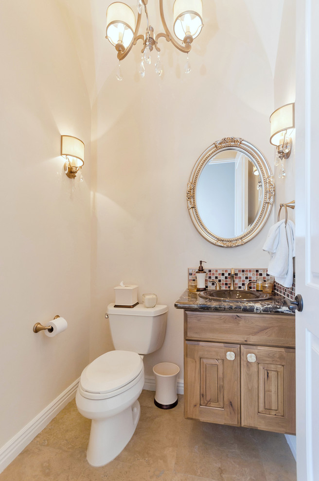 Example of a transitional mosaic tile travertine floor powder room design in Phoenix with raised-panel cabinets, medium tone wood cabinets, granite countertops, a two-piece toilet and beige walls