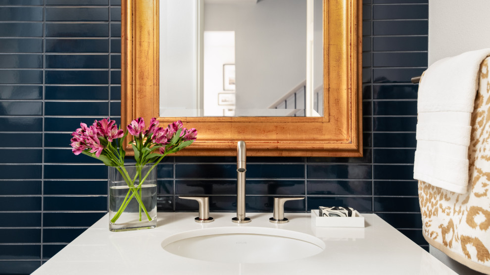 Inspiration for a small transitional blue tile and ceramic tile light wood floor powder room remodel in Seattle with flat-panel cabinets, blue cabinets, a one-piece toilet, white walls, an undermount sink, quartz countertops and white countertops