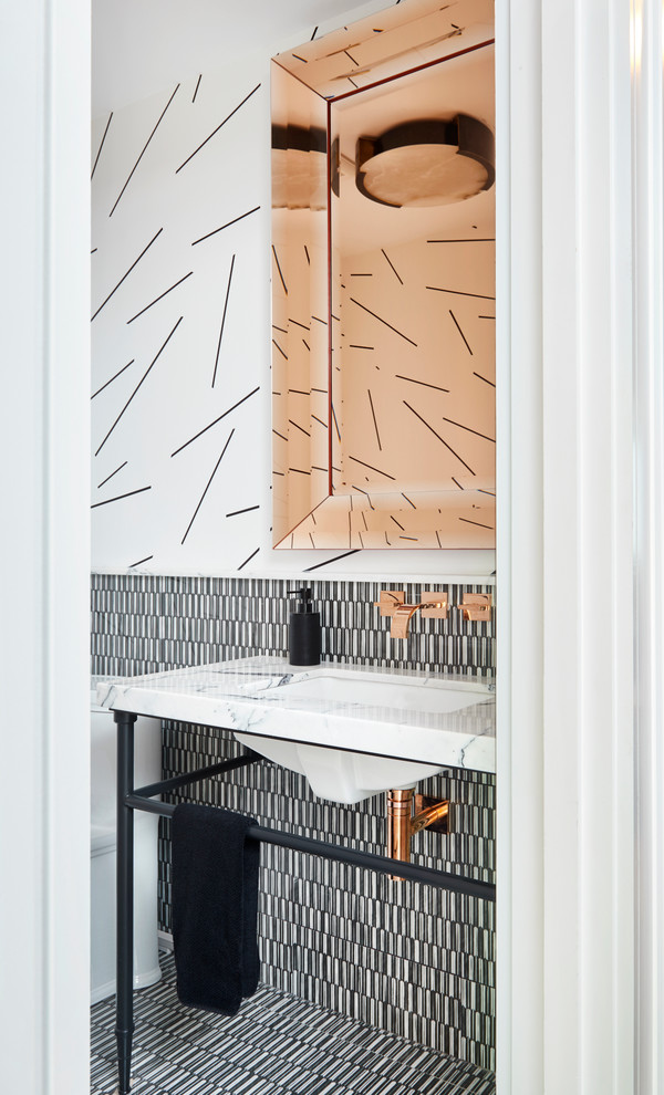 This is an example of a contemporary cloakroom in Toronto with black tiles, black and white tiles, multi-coloured tiles, white tiles, multi-coloured walls, a console sink and multi-coloured floors.