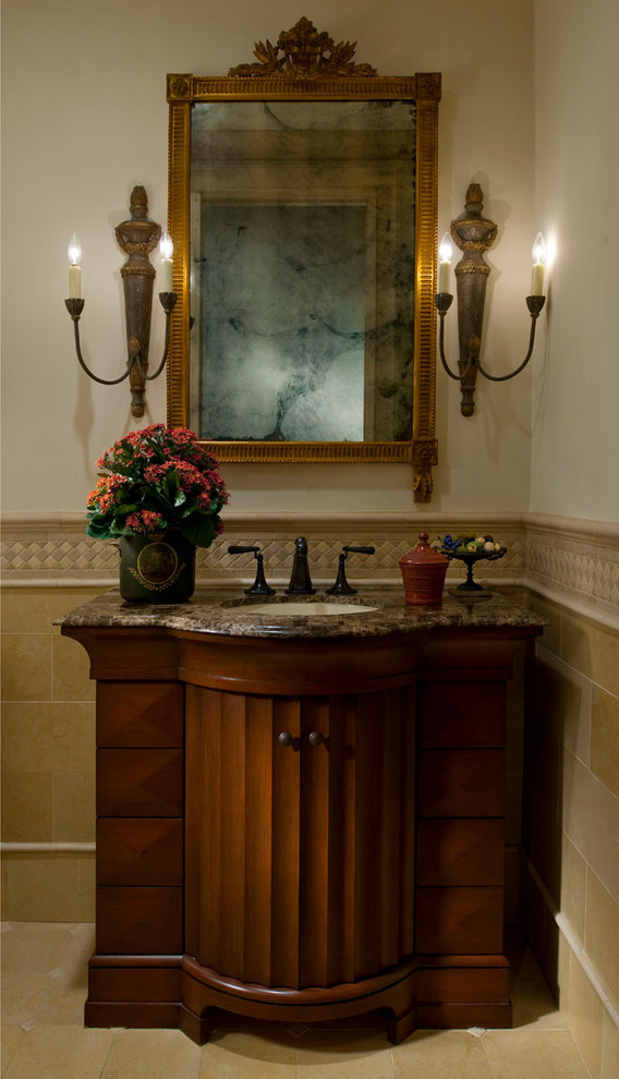 Photo of a large traditional cloakroom in Dallas with a submerged sink, freestanding cabinets, dark wood cabinets, marble worktops, beige tiles, stone tiles and travertine flooring.