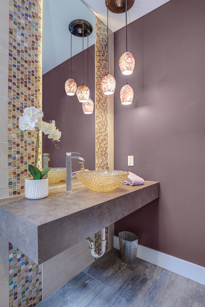 Design ideas for a small contemporary cloakroom in Seattle with multi-coloured tiles, mosaic tiles, purple walls, dark hardwood flooring, a vessel sink and brown floors.