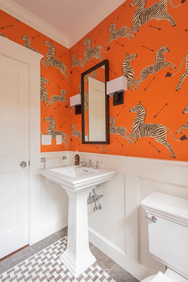 Example of a small transitional gray floor powder room design in Boston with a two-piece toilet, orange walls and a pedestal sink