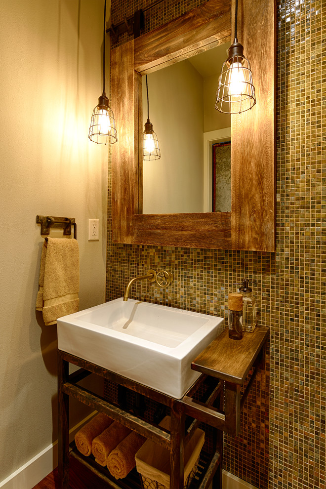 Cette image montre un WC et toilettes traditionnel de taille moyenne avec une vasque, un plan de toilette en bois, un carrelage multicolore, un carrelage en pâte de verre, un mur blanc et un plan de toilette marron.