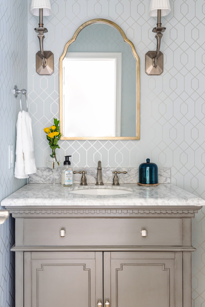 Photo of a classic cloakroom in Houston with recessed-panel cabinets, grey cabinets, white walls, a submerged sink, white worktops, a built in vanity unit and wallpapered walls.