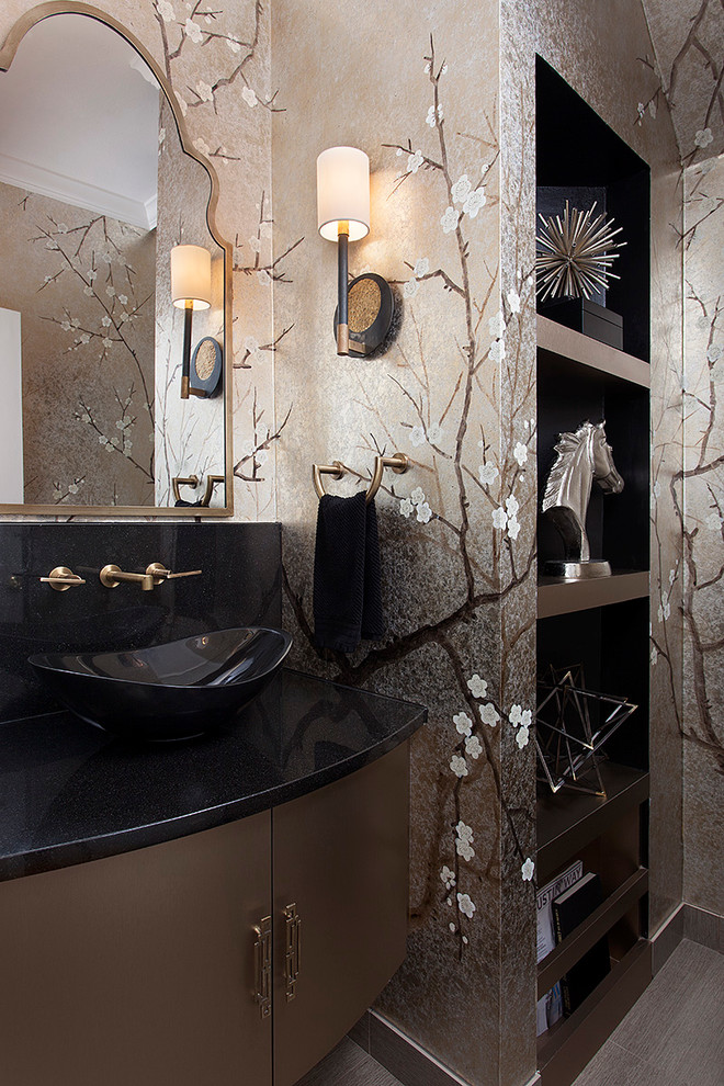 Inspiration for a small traditional cloakroom in Austin with freestanding cabinets, a one-piece toilet, black tiles, porcelain tiles, porcelain flooring, a vessel sink, granite worktops and brown cabinets.