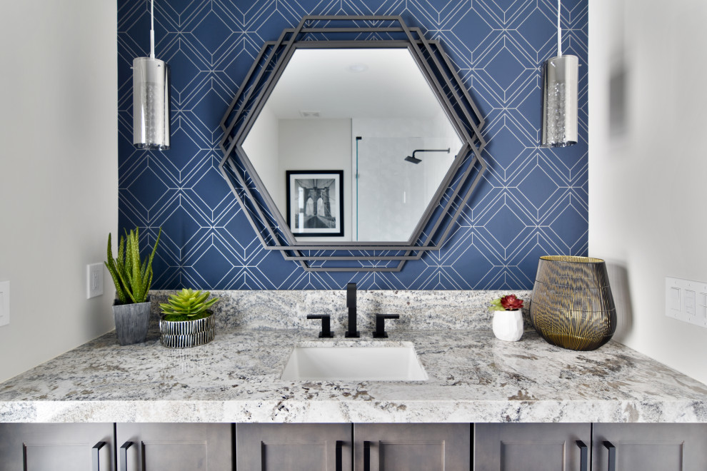 Powder room - transitional wallpaper powder room idea in Phoenix with shaker cabinets, gray cabinets, blue walls, an undermount sink, gray countertops and a built-in vanity