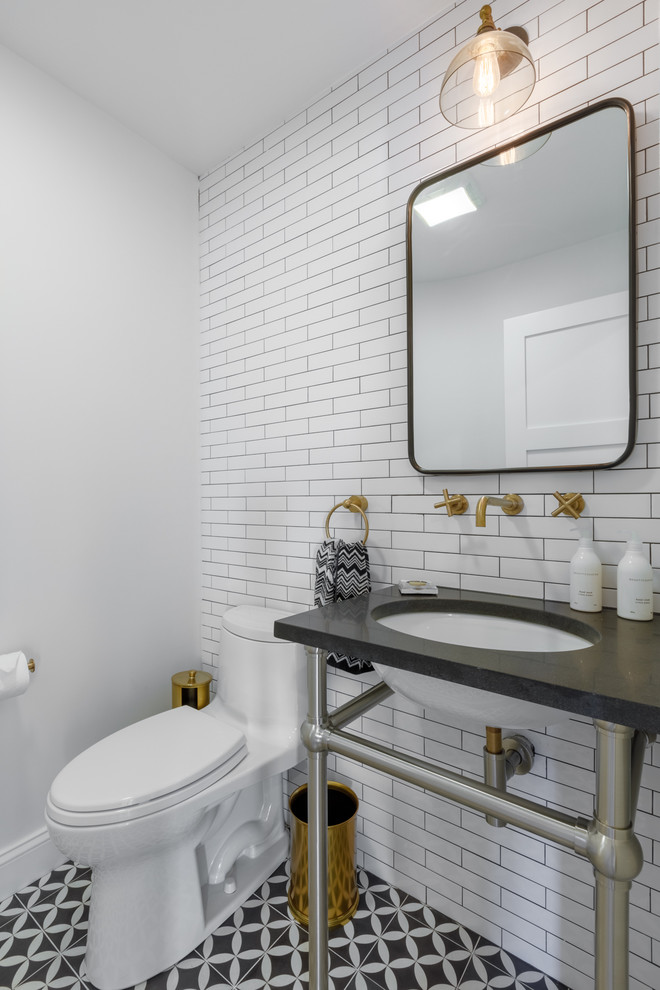 Example of a transitional white tile and subway tile ceramic tile and black floor powder room design in Other with white walls, an undermount sink and black countertops