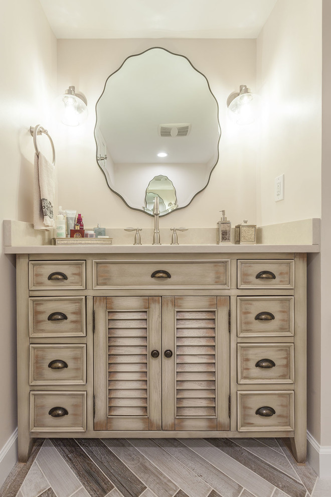Powder room - mid-sized transitional porcelain tile and beige floor powder room idea in DC Metro with furniture-like cabinets, beige walls, an undermount sink, quartz countertops, beige countertops and beige cabinets