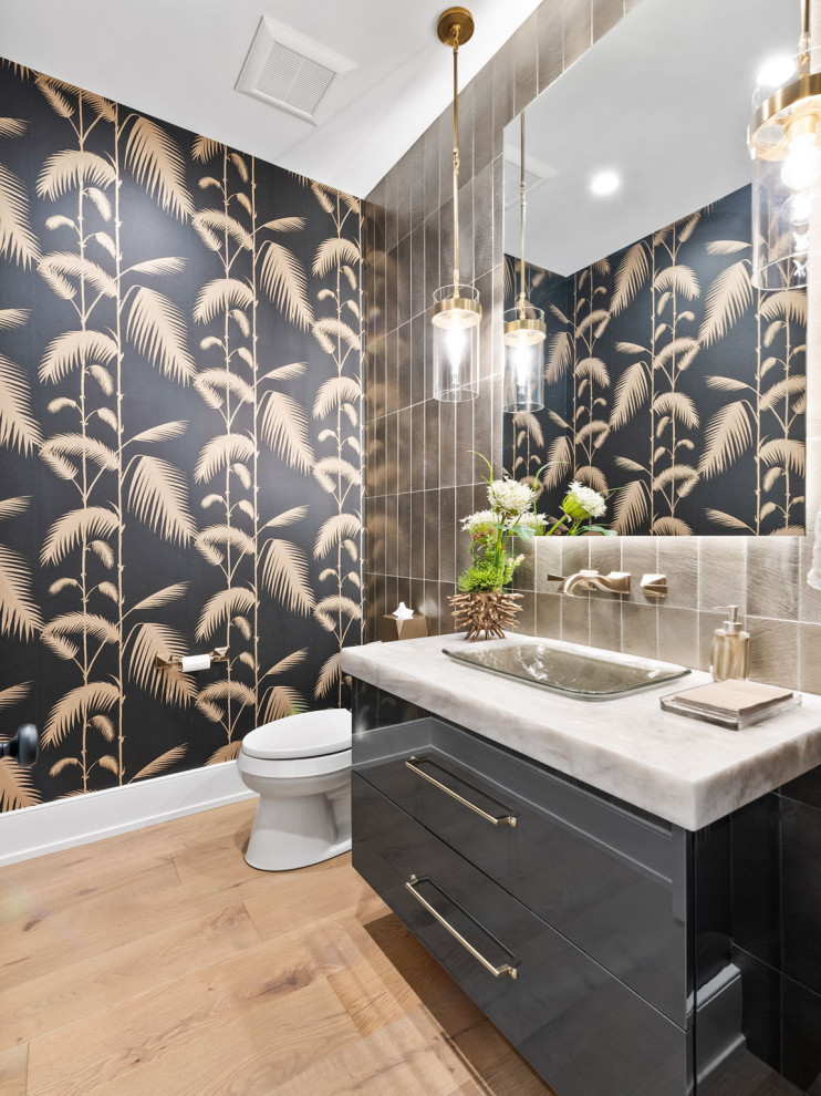 Design ideas for a large classic cloakroom in Chicago with flat-panel cabinets, grey cabinets, porcelain tiles, black walls, light hardwood flooring, quartz worktops, white worktops, a floating vanity unit, wallpapered walls, grey tiles, a built-in sink and beige floors.