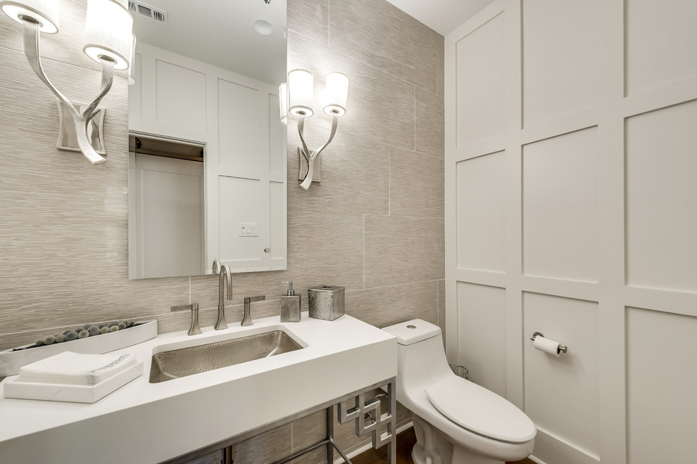 Large classic cloakroom in Dallas with open cabinets, a one-piece toilet, beige tiles, limestone tiles, white walls, medium hardwood flooring, a submerged sink, engineered stone worktops, brown floors and white worktops.