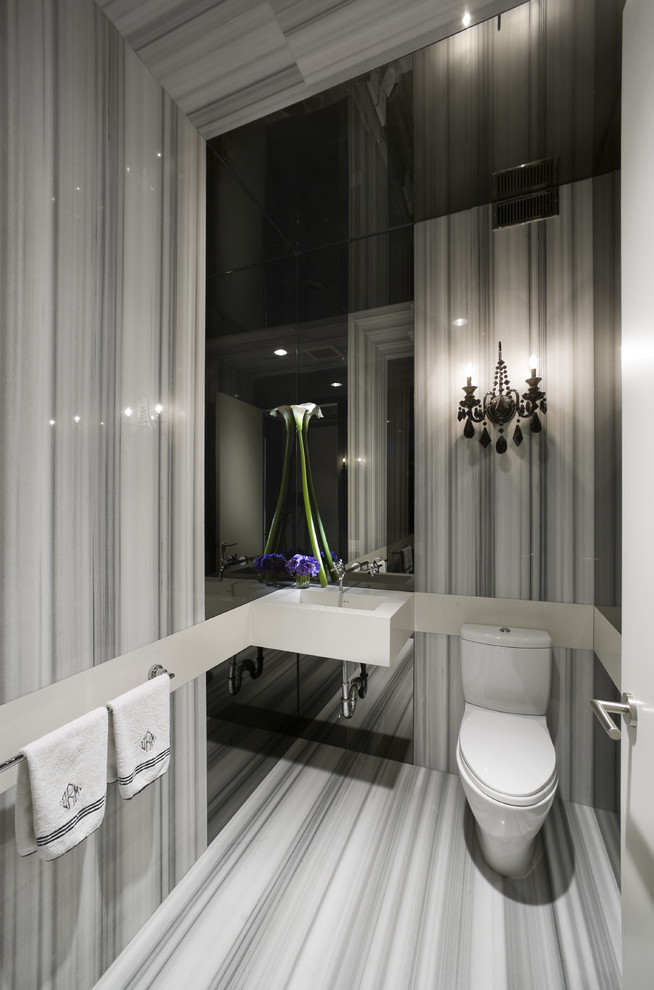 Idées déco pour un WC et toilettes contemporain avec un lavabo suspendu, un carrelage gris et un mur gris.