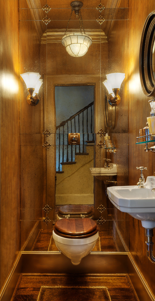 На фото: туалет в классическом стиле с инсталляцией, коричневыми стенами, паркетным полом среднего тона, подвесной раковиной и коричневым полом с