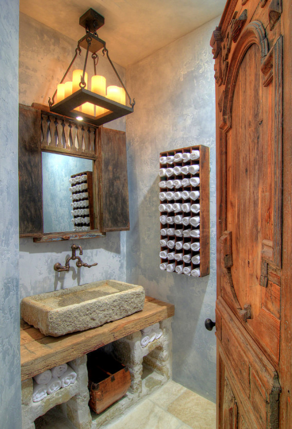 Inspiration for a medium sized mediterranean cloakroom in Los Angeles with blue walls, a vessel sink, open cabinets, grey cabinets, ceramic flooring, wooden worktops and beige floors.