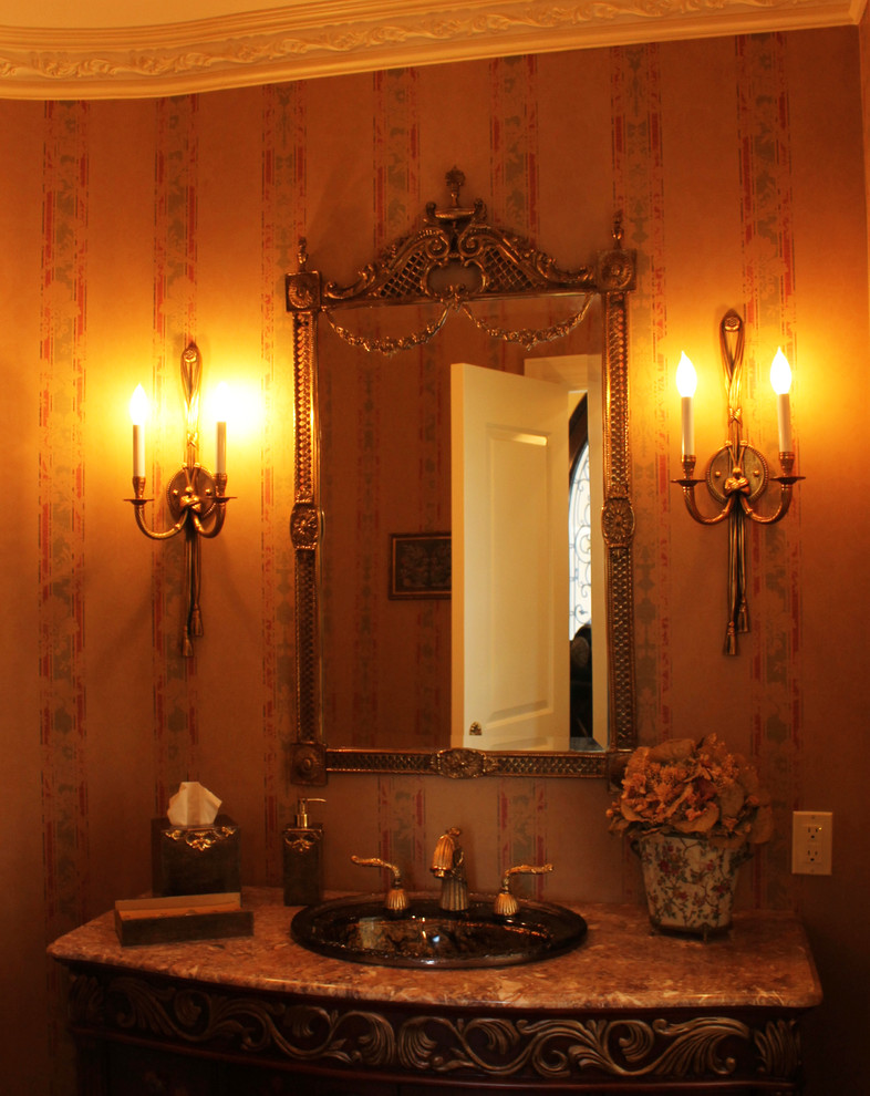 Inspiration for a mid-sized mediterranean stone tile powder room remodel in New York with furniture-like cabinets, beige walls and a vessel sink