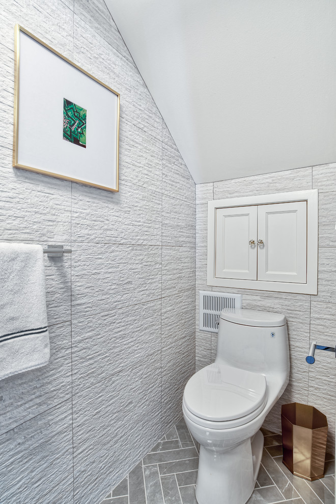 Small modern cloakroom in New York with a one-piece toilet, beige tiles, ceramic tiles, beige walls, marble flooring, a vessel sink, wooden worktops, grey floors and brown worktops.