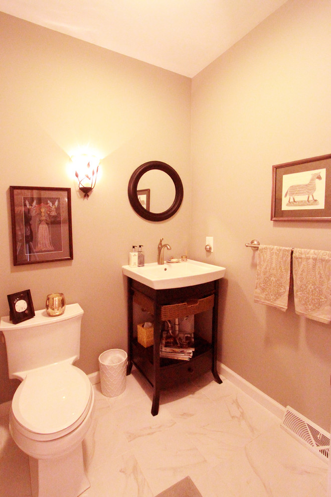 Photo of a classic cloakroom in Philadelphia with dark wood cabinets, a one-piece toilet, brown walls, porcelain flooring and an integrated sink.