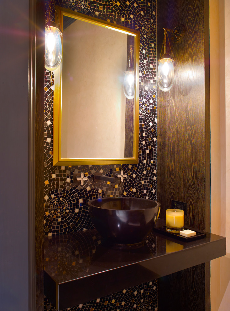 Example of a mid-sized classic multicolored tile and glass tile powder room design in Charleston with beige walls, a vessel sink, solid surface countertops and black countertops