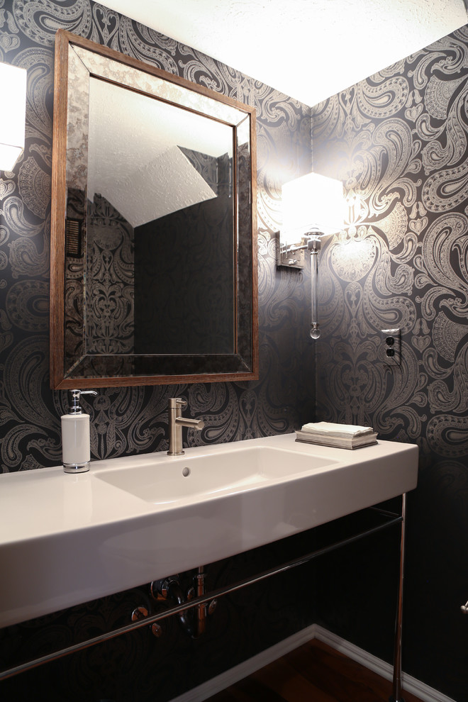 Photo of a medium sized contemporary cloakroom in Indianapolis with a one-piece toilet, white tiles, stone slabs, black walls, medium hardwood flooring and a trough sink.
