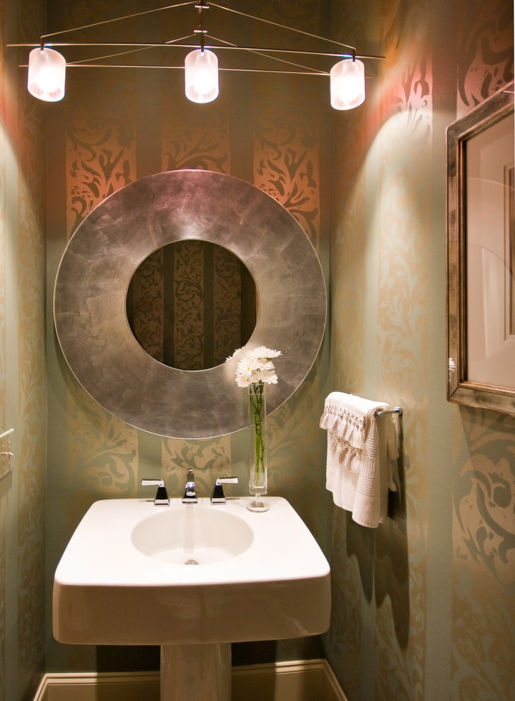 Example of a small trendy powder room design in Charleston with a pedestal sink and multicolored walls